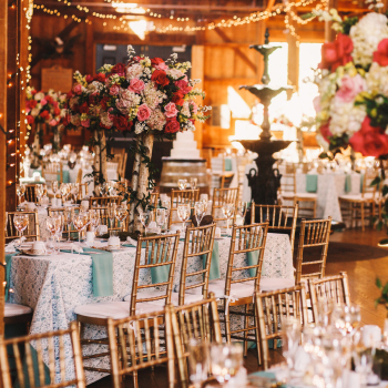 Rich dinner tables covered with blue clothes and sparkling glass